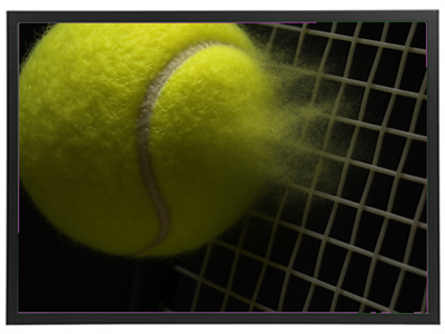 Et nærbillede af en tennisbold, der rammer nettet, med støvpartikler, der flyver.