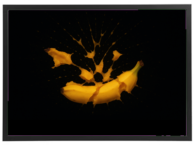 Et dramatisk billede af en banan, der splintres med sprøjtende væske mod en sort baggrund.