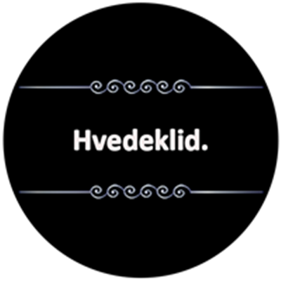 Billedet viser teksten Hvedeklid på en sort baggrund, indrammet af dekorative elementer.
